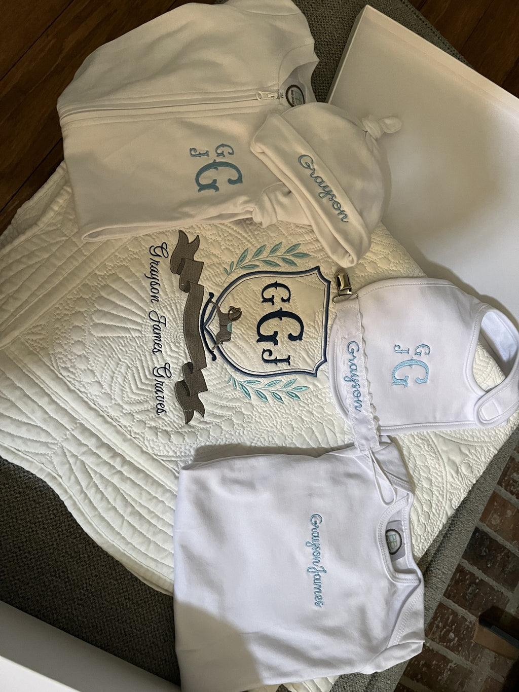 Personalized baby gift set embroidered for Grayson James: crest blanket, gown, knot hat, bib and bodysuit