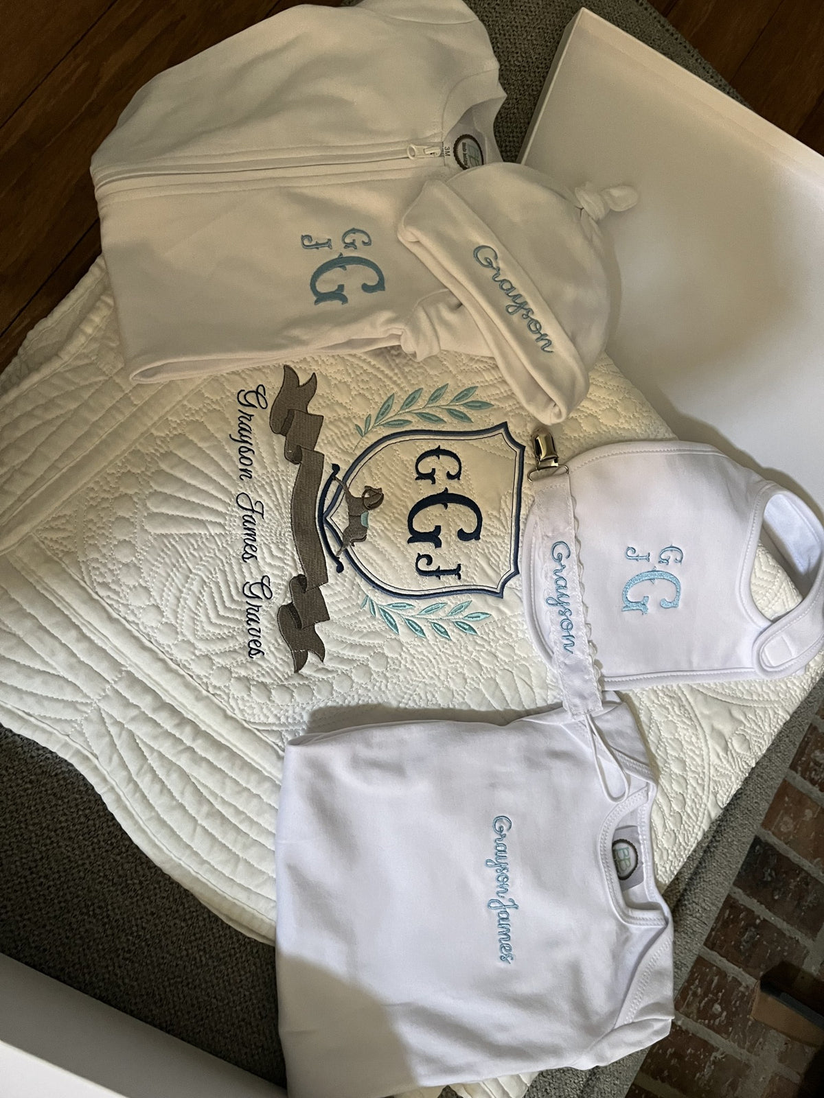 Personalized baby gift set embroidered for Grayson James: crest blanket, gown, knot hat, bib and bodysuit
