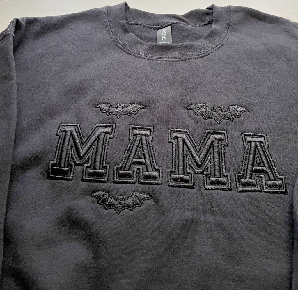 Black crewneck sweatshirt with black embroidered MAMA varsity letters and three bats